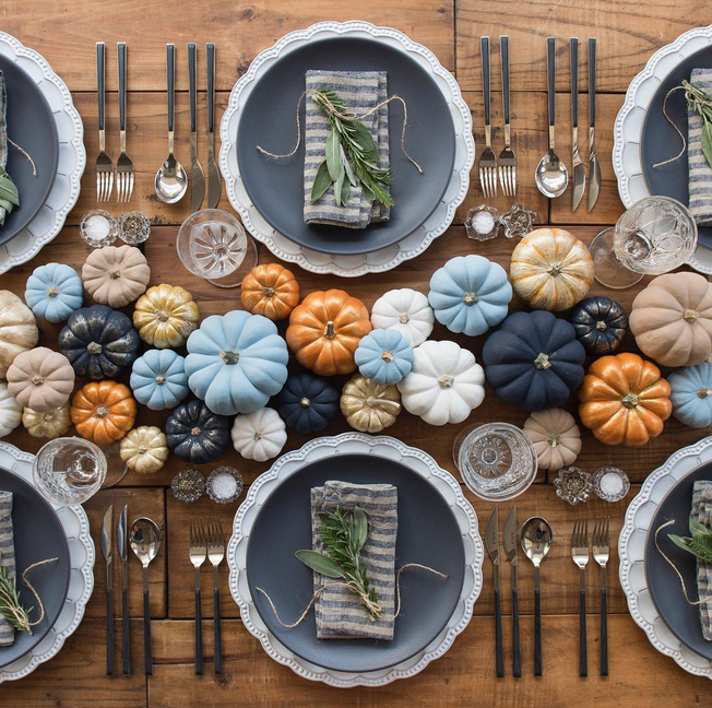 Forget the table runner, just use pumpkins! Take a different approach by adding in non-traditional colors. A group of 30+ mini pumpkins in varying sizes is an easy way to make a big statement.