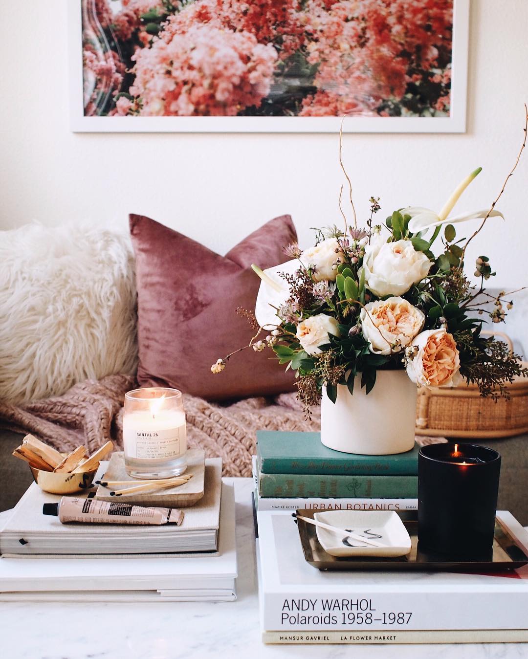 Studio Apartment Ideas: A coffee table can be the perfect stage for your favorite books, candles, and plants. A curated coffee table arrangement will show off your style and tie the room together. If you're looking for something non-traditional, vintage trunks, crates, wood slabs, and tree stumps make excellent alternatives.