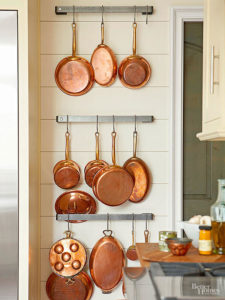 Your kitchen utensils and bakeware can serve not only you, but your decor, too! If you love your pots and pans them and use them often, try making a curated assortment. Hanging racks are usually suspended from the ceiling, but you can also perch your pots and pans on the wall. / wall storage for pans / theanastasiaco.com