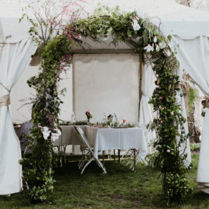 Walking into this event was like stepping foot in a secret garden. The dreamy details included an arch filled with flowers and greenery, a delicious catered meal, personalized wine bottle labels, fresh-cut bouquets, string lights, and thoughtful place settings. Creating a beautiful ambiance for your event is all in the details. Host a magical backyard rehearsal dinner party with these four simple tips! / theanastasiaco.com